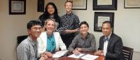 Six healthcare professionals sitting in an corner office space